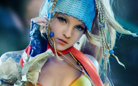 A stunning HD wallpaper featuring a woman in vibrant cosplay as Rikku from Final Fantasy X-2, showcasing intricate details and dynamic styling.