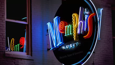 HD photography of a vibrant neon Memphis sign glowing against a dark wall, featured as a striking PC desktop wallpaper and background.