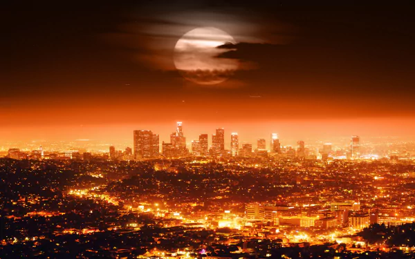 A stunning HD desktop wallpaper showcasing the illuminated skyline of Los Angeles under a dramatic, orange-tinted sky with a vigilant moon casting its glow.