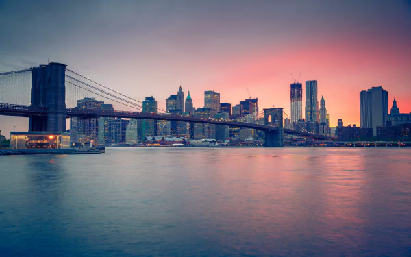 2K Quad HD PC desktop wallpaper of the man-made Brooklyn Bridge spanning the East River with Manhattan skyline at sunset.