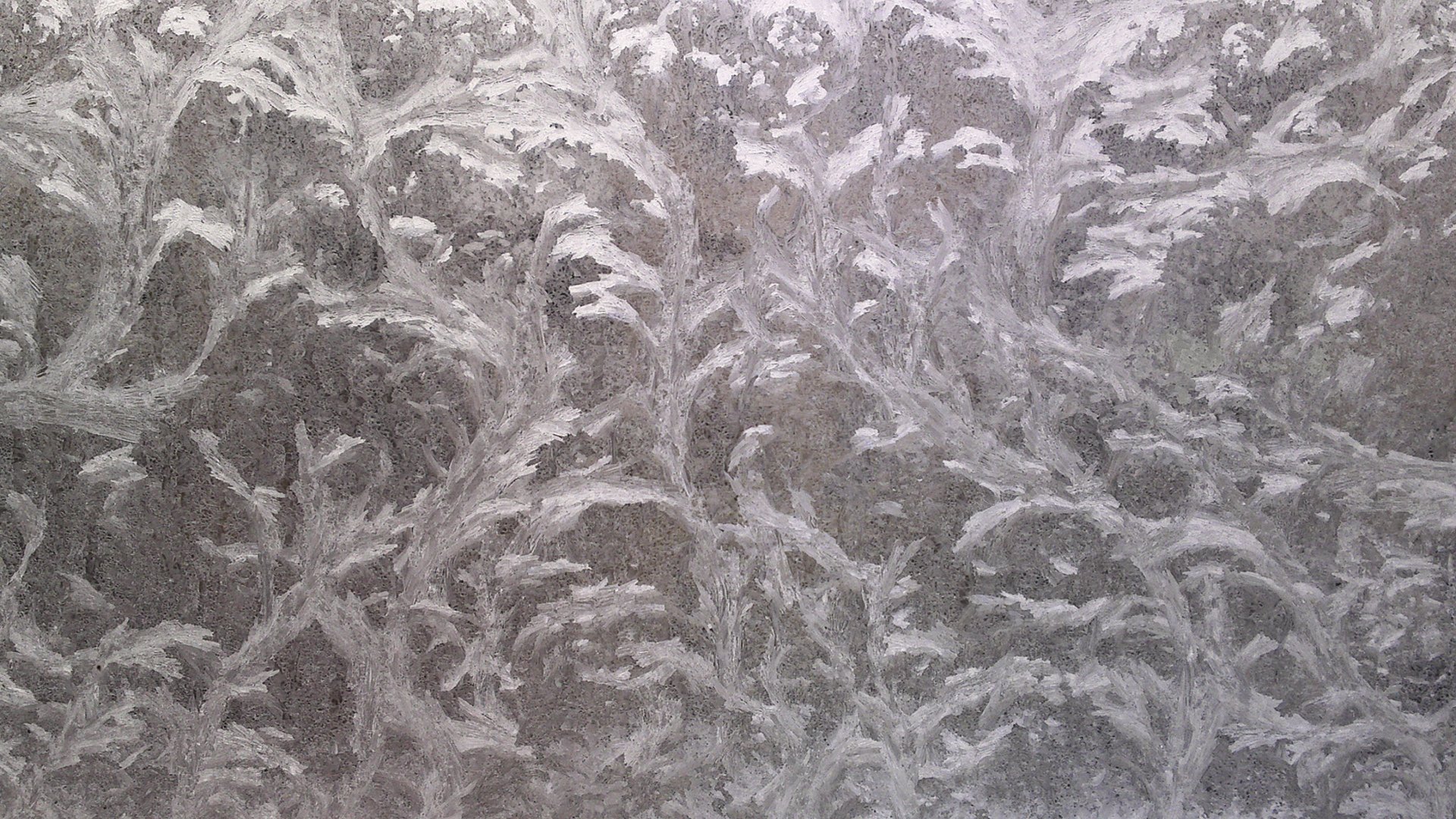 HD PC desktop wallpaper featuring an abstract textured surface with intricate, swirling patterns in muted gray tones.