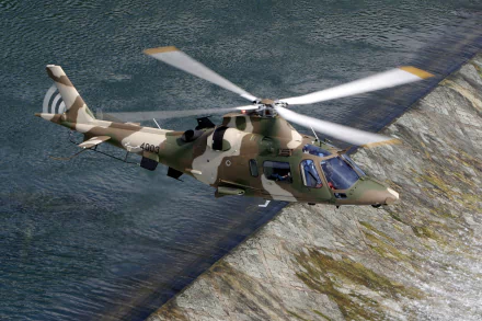 HD military-themed desktop wallpaper featuring an AgustaWestland AW109 helicopter flying over rugged terrain and water.