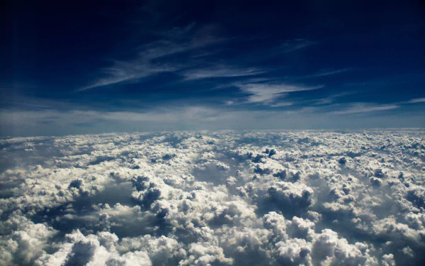 A breathtaking view of fluffy, white clouds under a deep blue sky, showcasing the beauty of nature. This HD image serves as a stunning desktop wallpaper and background.