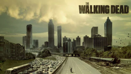 HD desktop wallpaper featuring a desolate cityscape from The Walking Dead, showcasing abandoned vehicles on a highway and a dark, atmospheric skyline.