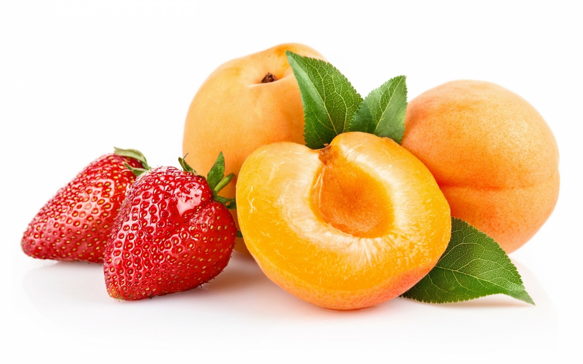 HD PC desktop wallpaper featuring fresh apricots and strawberries with green leaves on a white background, showcasing vibrant food and fruit colors.