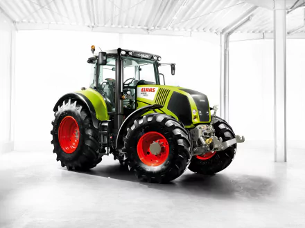 HD desktop wallpaper of a Claas Axion tractor, showcasing its bright green body and large red wheels in a clean, well-lit indoor setting.