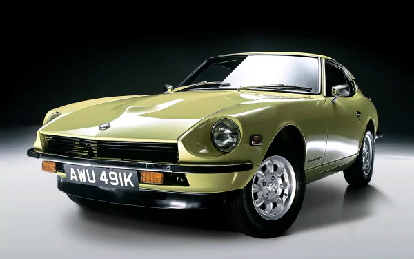 HD PC desktop wallpaper of a classic olive-green Datsun sports car in studio lighting, shown front three-quarter on a neutral background.