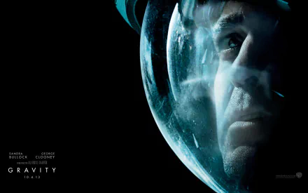 A dramatic HD desktop wallpaper featuring George Clooney in a space helmet, capturing a poignant moment from the movie Gravity (2013).
