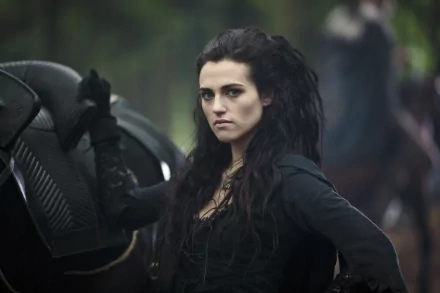 Morgana Pendragon, portrayed by Katie McGrath in the TV show Merlin (2008), stands confidently with a dramatic expression, set against a forest backdrop in this 4K Ultra HD wallpaper.