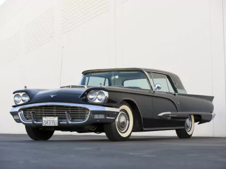 HD desktop wallpaper featuring a classic black Ford Thunderbird parked against a plain white wall, showcasing its vintage design and sleek lines.