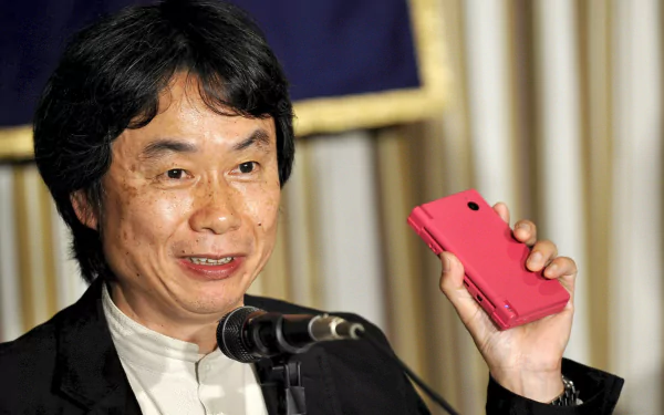 HD desktop wallpaper featuring a smiling person holding a red handheld device, set against an elegant background.