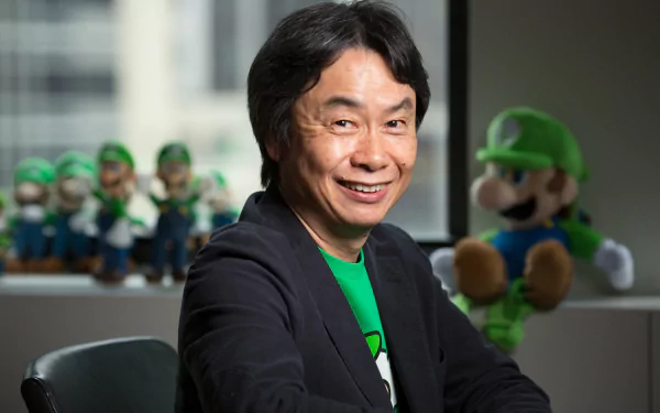 HD desktop wallpaper featuring a smiling person with a collection of Luigi figurines and a plush in the background.