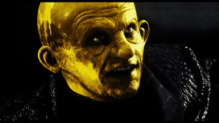 HD PC desktop wallpaper featuring a close-up of a sinister, yellow-lit character from the movie Sin City against a dark background.