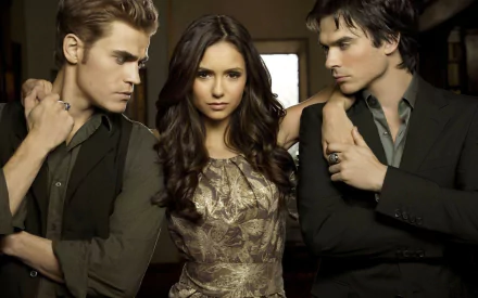 High-definition wallpaper featuring characters from The Vampire Diaries: a striking trio with a woman at the center, flanked by two men, set against a mysterious backdrop.