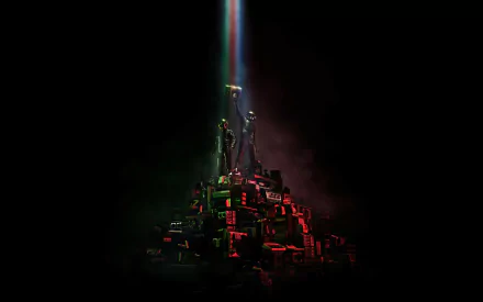 A vibrant HD desktop wallpaper featuring Daft Punk, showcasing two figures atop a pyramid of colorful objects, illuminated by a striking beam of light against a dark background.