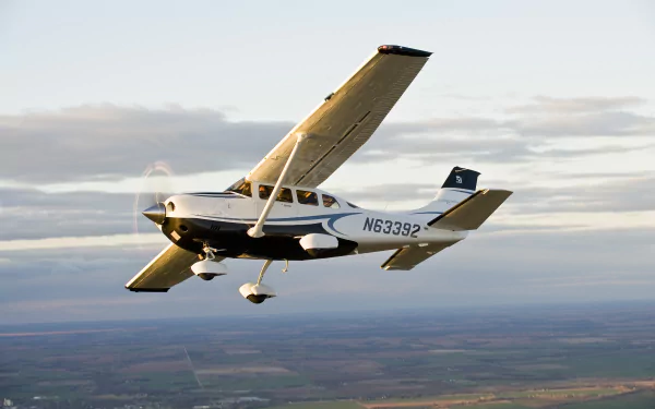 A Cessna aircraft flying over a landscape at sunset, captured in high definition for a PC desktop wallpaper background.