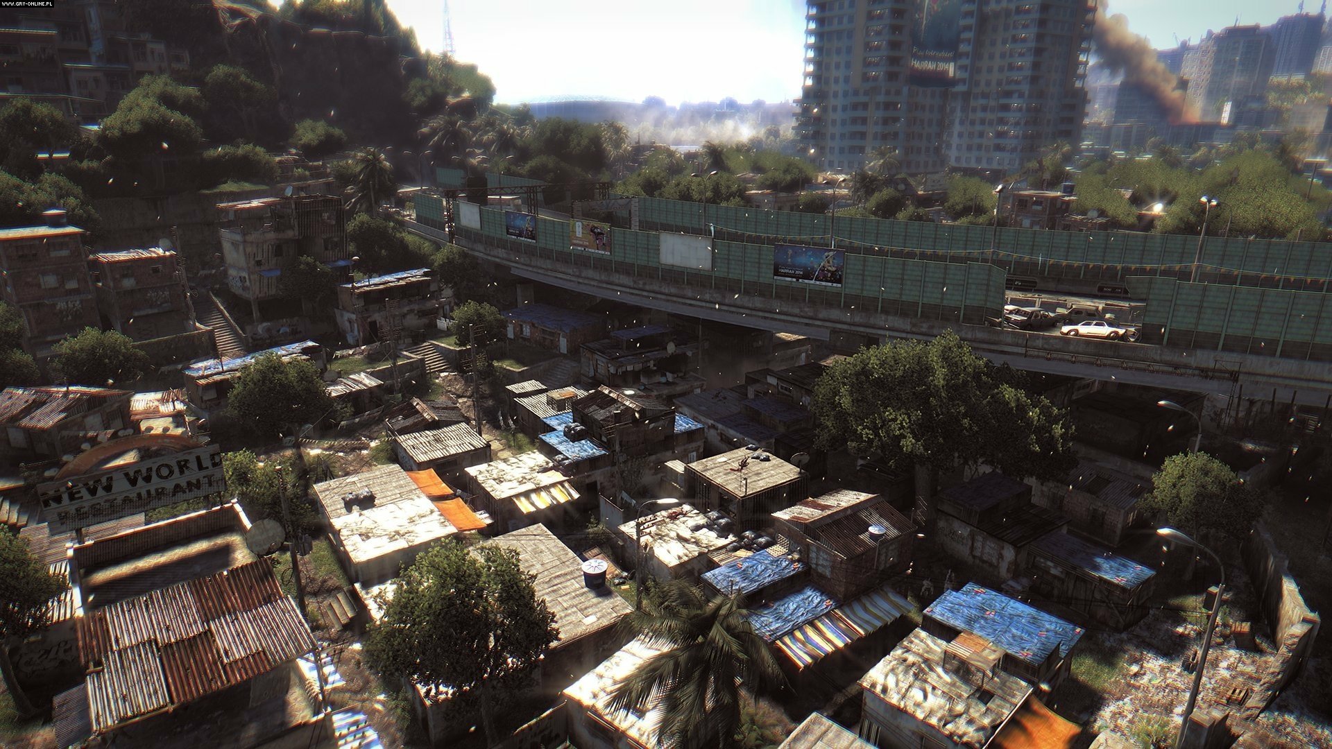 HD PC desktop wallpaper and background from the video game Dying Light: sunlit shantytown beneath an overpass with a distant high‑rise skyline.