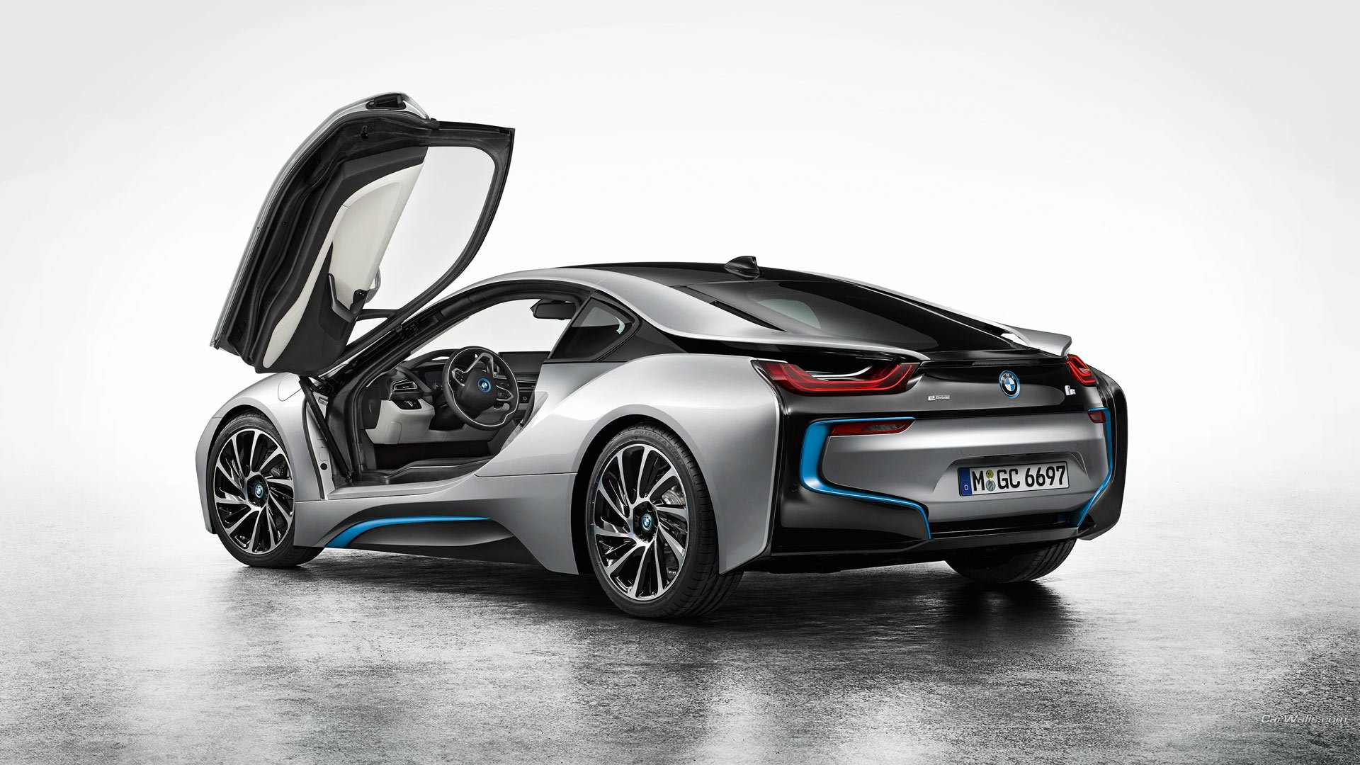 Silver BMW i8 with butterfly door open, rear three-quarter studio view on a reflective floor — HD PC desktop wallpaper/background