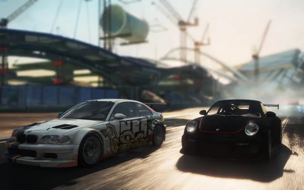 HD PC desktop wallpaper featuring intense street racing action from the video game Need for Speed: Most Wanted, showcasing two detailed cars speeding on an urban track.