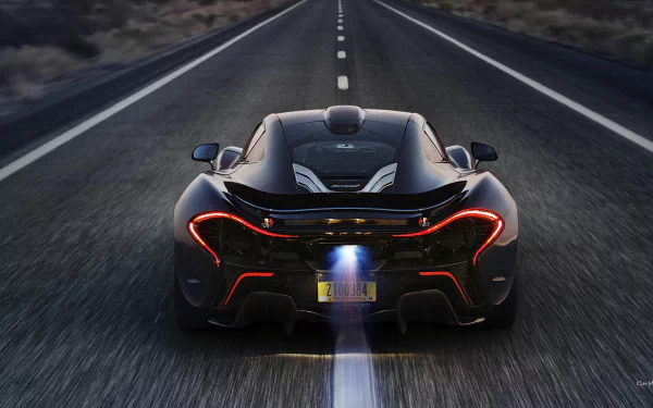 HD wallpaper of a McLaren P1 speeding down a highway with glowing taillights and a dynamic blur effect.