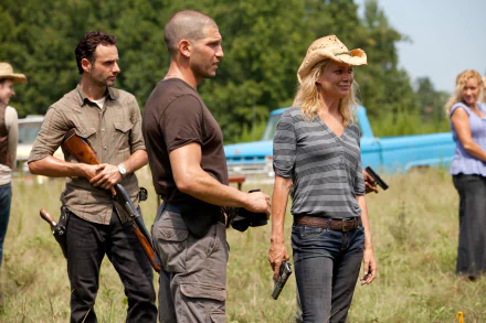 A dynamic scene from *The Walking Dead* featuring Shane (Jon Bernthal) and Andrea (Laurie Holden), set against a rustic backdrop, capturing the show's intense atmosphere.