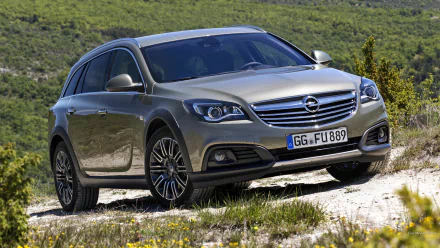 HD desktop wallpaper: metallic 2014 Opel Insignia Country Tourer on a sunlit gravel track, angled three-quarter view with rolling green hills in the background.