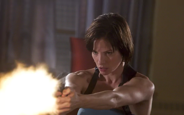 Female character from Resident Evil: Apocalypse firing a handgun in an intense close-up — 2K Quad HD PC desktop wallpaper background.