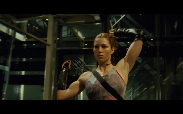 HD PC desktop wallpaper from the movie Blade: Trinity showing a red-haired female vampire hunter in tactical gear raising her arm amid a green-lit industrial interior.