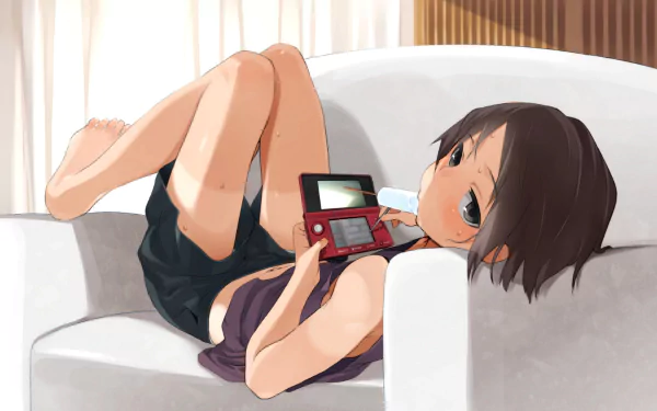 A relaxed anime girl with short hair enjoys ice cream while playing on a handheld gaming device, lounging comfortably on a sofa in a cozy setting.