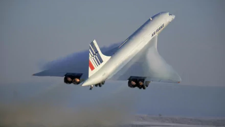 A Concorde aircraft takes off against a clear blue sky, leaving a vapor trail, set against the backdrop of Place de la Concorde. A striking HD desktop wallpaper and background.