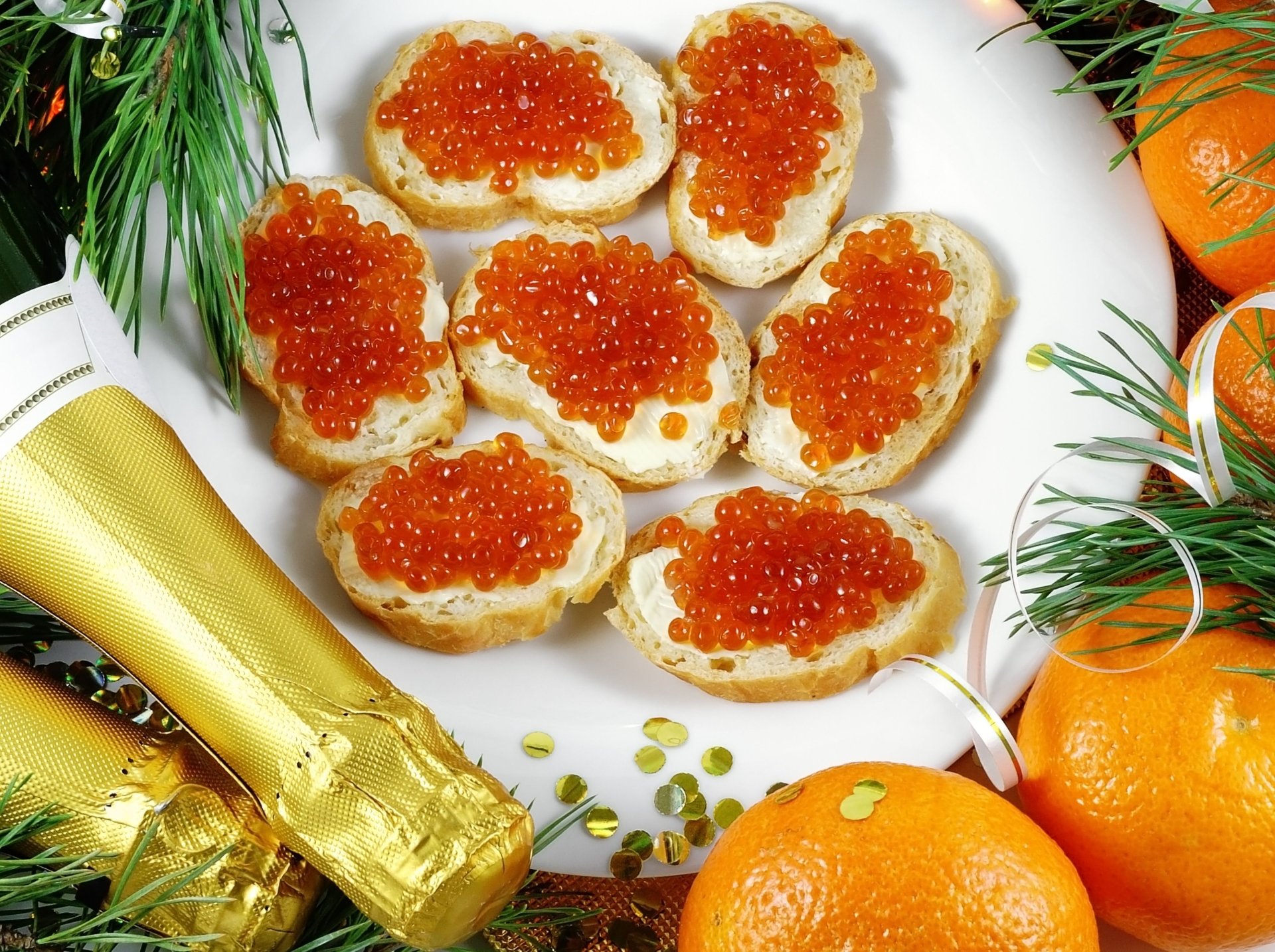 4K Ultra HD wallpaper featuring a close-up of caviar-topped canapés on a plate, accompanied by a champagne bottle and festive fruits, creating a luxurious food setting.