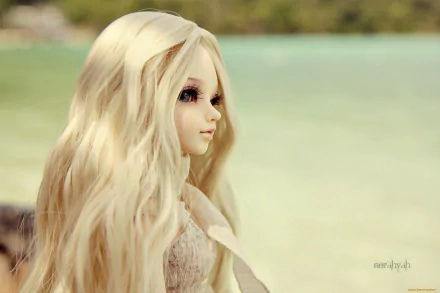 HD desktop wallpaper featuring a close-up of a man-made doll with long blonde hair against a blurred natural background.