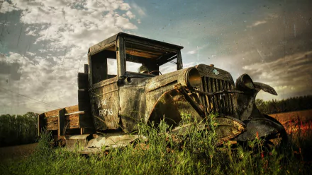 HD PC desktop wallpaper featuring an old, rusted vehicle wreck resting in a grassy field under a cloudy sky.