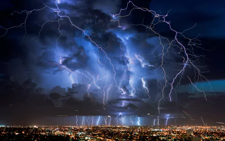HD desktop wallpaper featuring a vivid display of multiple lightning strikes over a cityscape at night, set against a dramatically clouded horizon.