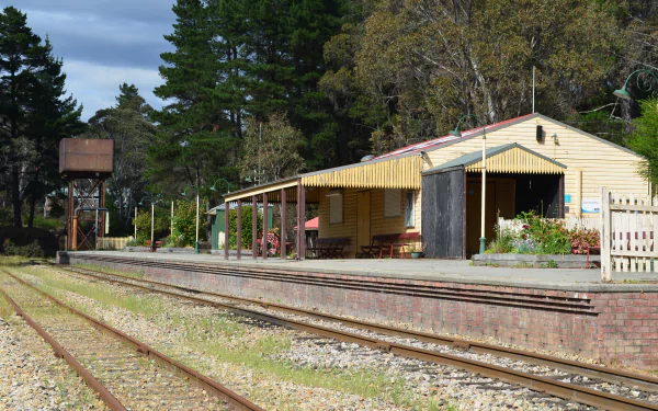 Clarence Railway Station, Lithgow — man-made railroad building and platform beside multiple tracks, set among trees. HD PC desktop wallpaper and background.