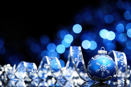 HD wallpaper of blue Christmas ornaments and holiday decorations with a beautiful bokeh light effect in the background.