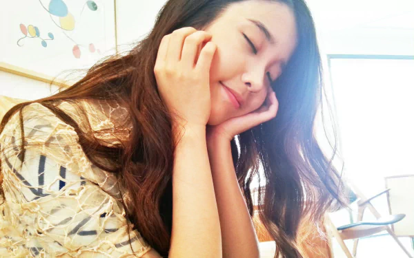 HD PC desktop wallpaper featuring Korean music star IU with a serene expression, capturing her gentle and peaceful vibe.