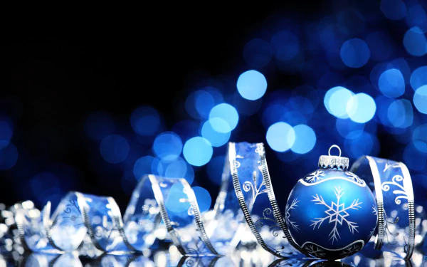 HD wallpaper of blue Christmas ornaments and holiday decorations with a beautiful bokeh light effect in the background.