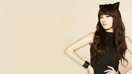 HD PC desktop wallpaper featuring Korean music star Bae Suzy in a black outfit with cat ears against a plain beige background.