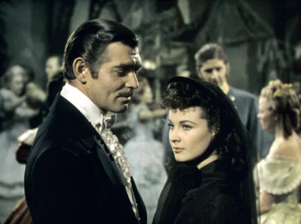 HD desktop wallpaper from the movie Gone With The Wind featuring Rhett Butler and Scarlett O’Hara in period costume during a social gathering.