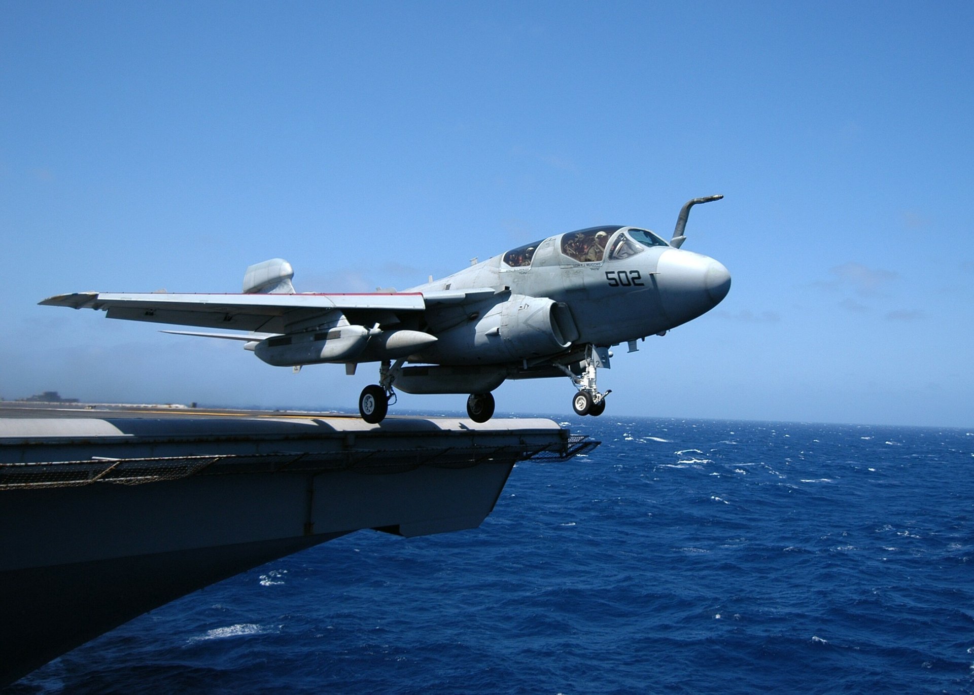 Northrop Grumman EA-6B Prowler launching from an aircraft carrier over blue ocean — military HD PC desktop wallpaper background.