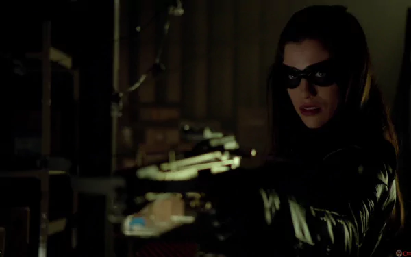 Huntress from DC Comics takes aim with a crossbow in this HD wallpaper, highlighting her fierce character from the TV show Arrow. A dark and dynamic background enhances the scene.