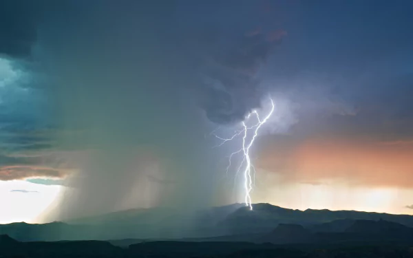 HD desktop wallpaper featuring a striking lightning bolt illuminating a stormy landscape at twilight.