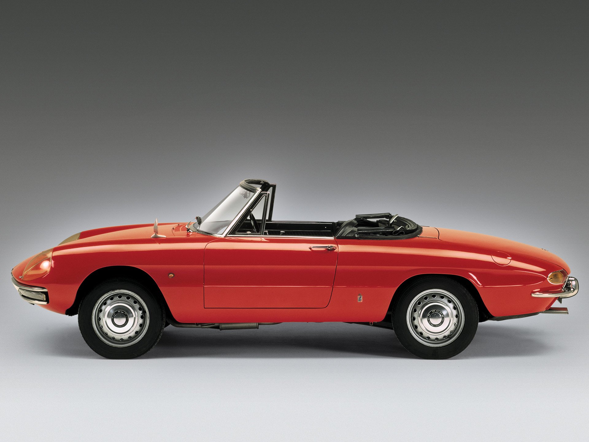 HD desktop wallpaper featuring a classic red Alfa Romeo Spider convertible, showcasing its sleek design and vintage automotive style.