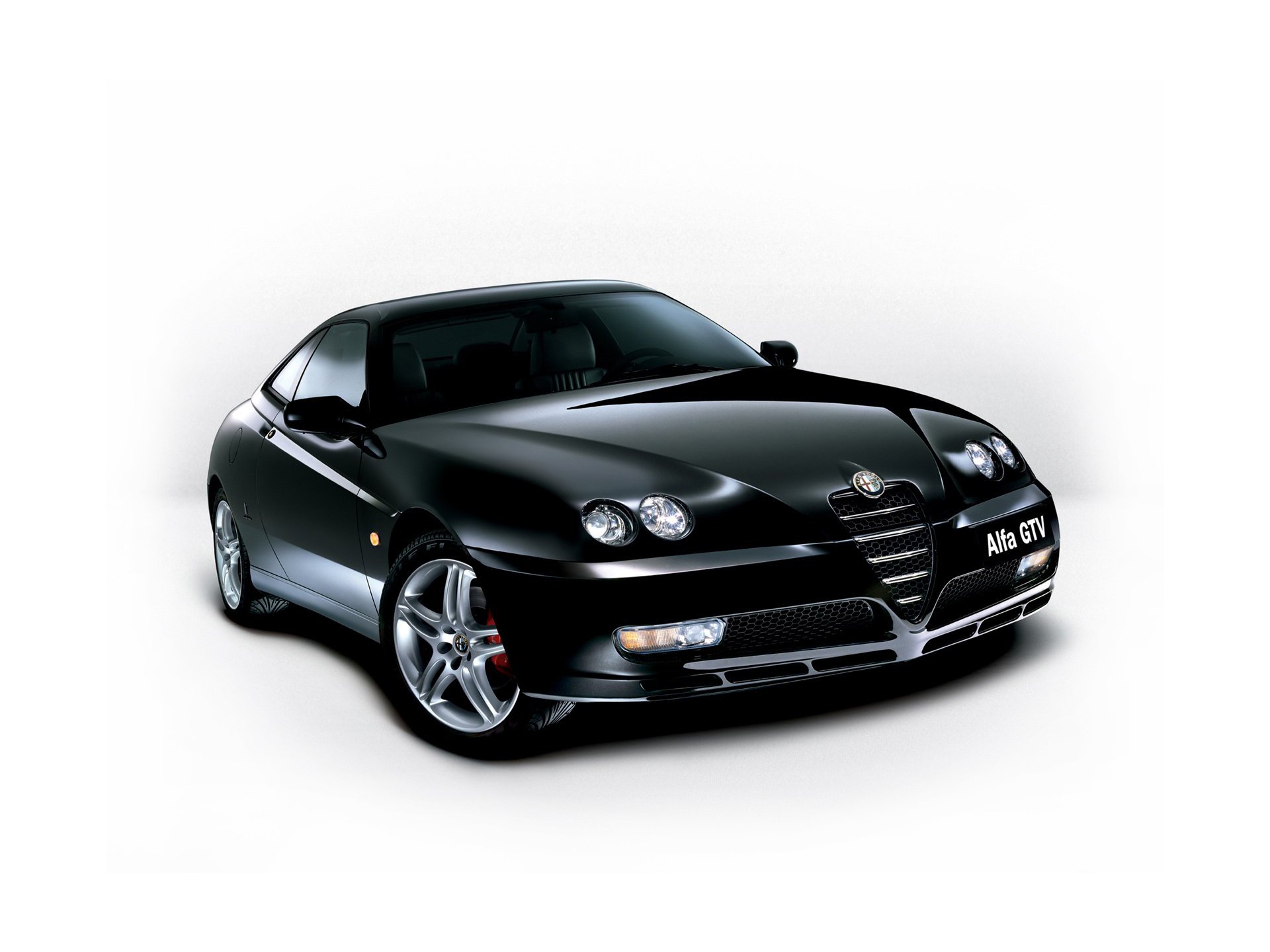 HD desktop wallpaper featuring a sleek black Alfa Romeo GTV sports car against a white background.
