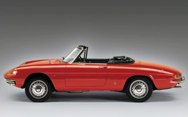 HD desktop wallpaper featuring a classic red Alfa Romeo Spider convertible, showcasing its sleek design and vintage automotive style.