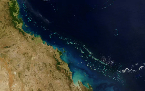 4K Ultra HD view of Earth from space showcasing coastal land and ocean, highlighting natural formations and vibrant colors in stunning detail.
