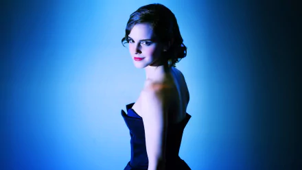 HD desktop wallpaper featuring actress Emma Watson in a dark strapless dress, presenting a vintage glamour look against a moody blue background.