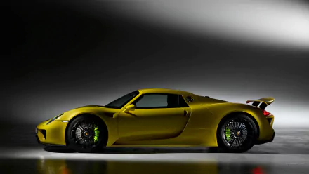 HD PC desktop wallpaper featuring a sleek yellow Porsche 918 Spyder sports car against a dramatic dark background.