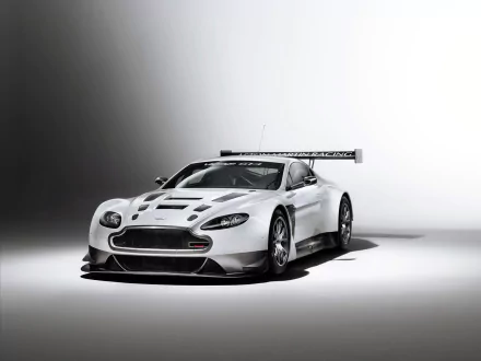 White Aston Martin V12 Vantage race vehicle on a minimalist studio backdrop, HD PC desktop wallpaper/background.